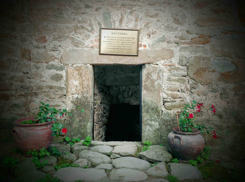 A sign that says that inside lies the bones of monks, freedom fighter, and area orthodox christians