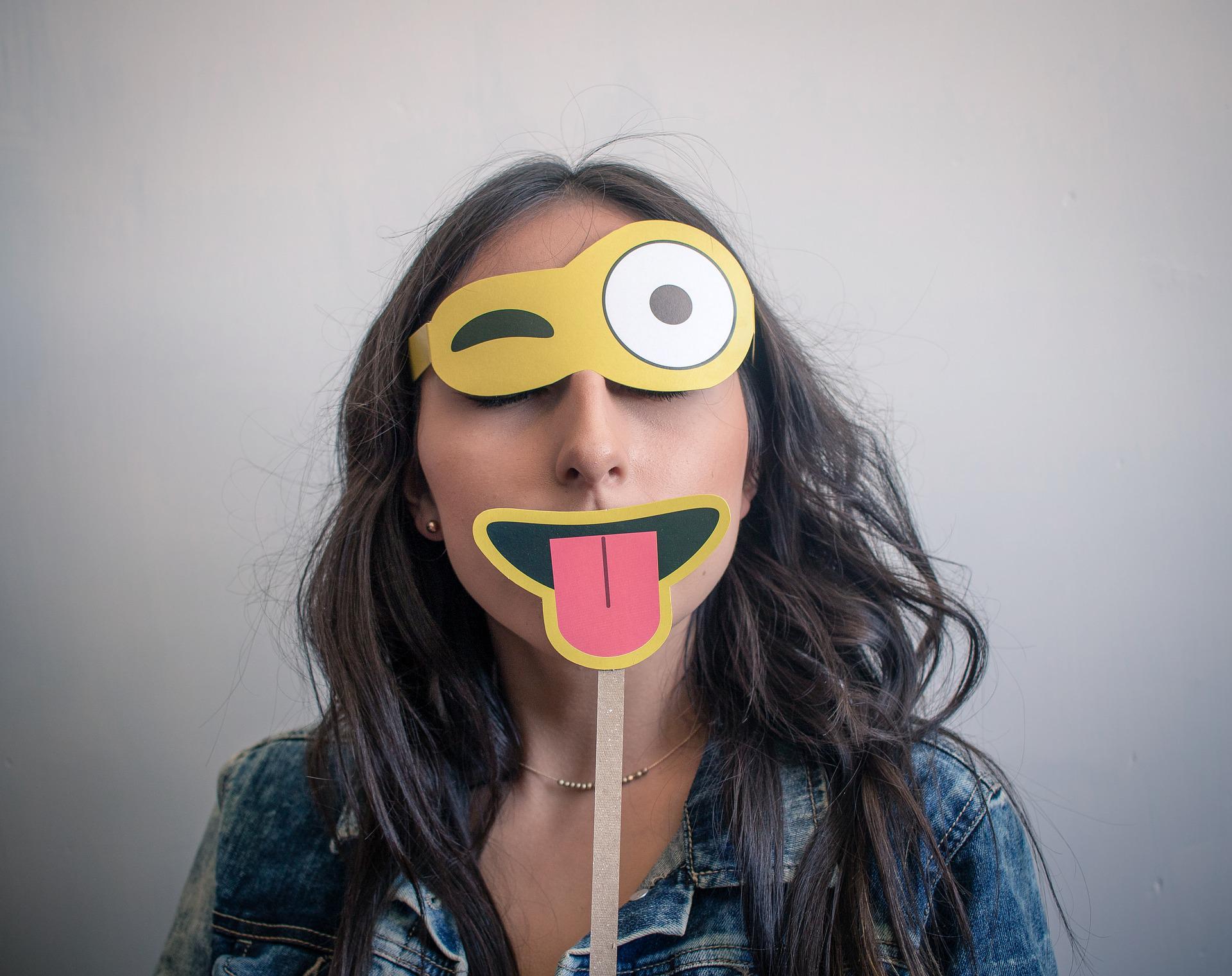 woman wearing an emoji mask